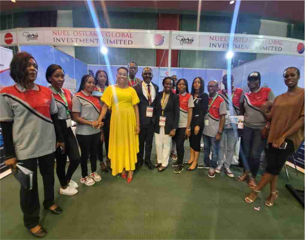 Staff of Nuel Osilama Global posed with their Brand Ambassador at during the International Housing Show Abuja 